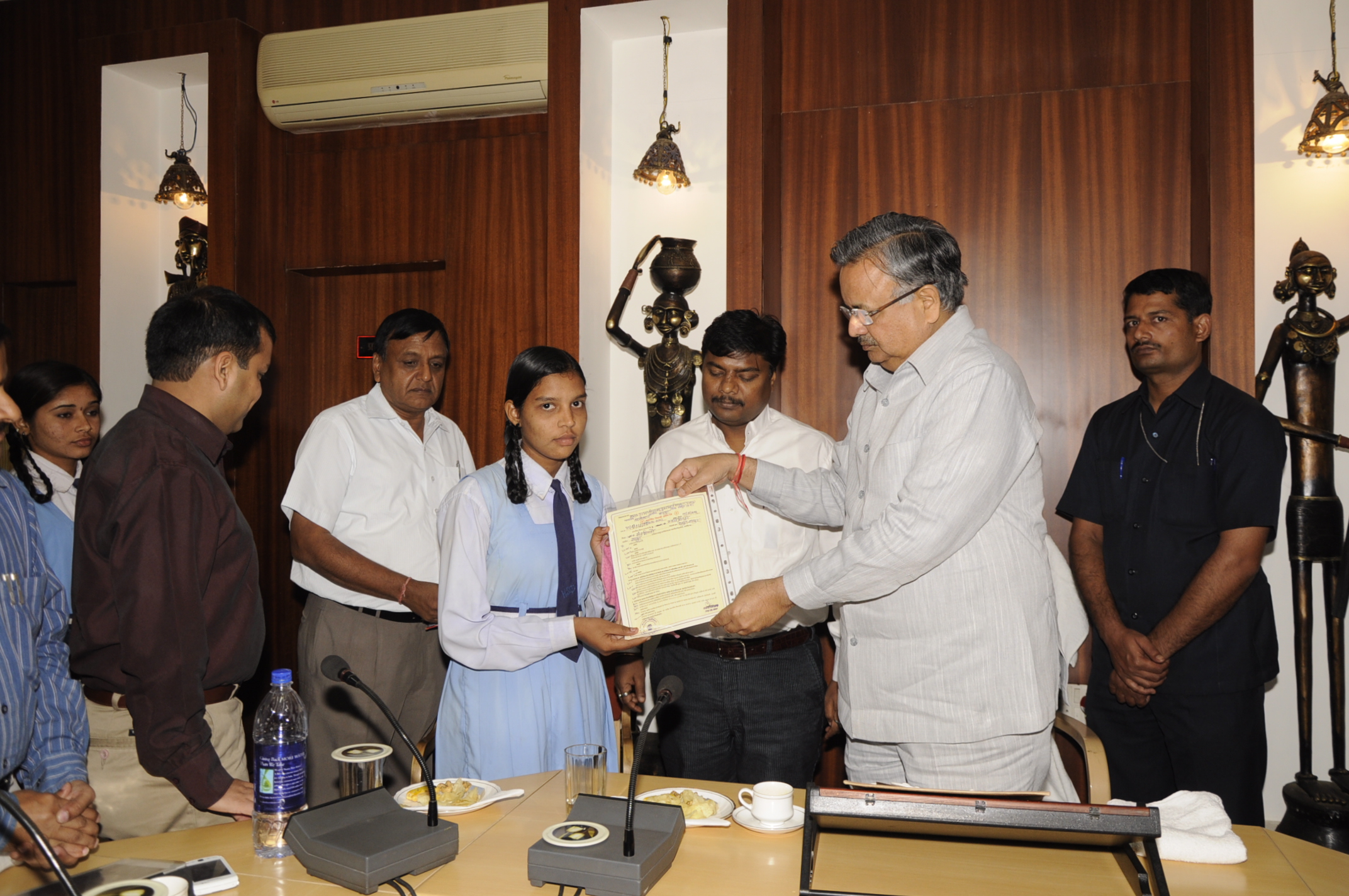 Chief Minister Dr. Raman Singh handing  the caste certificate to a student after inauguration