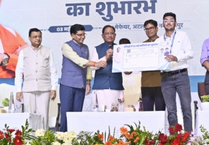 Honorable Chief Minister handing over the digitally signed Land Record document to a beneficiary during the launch event